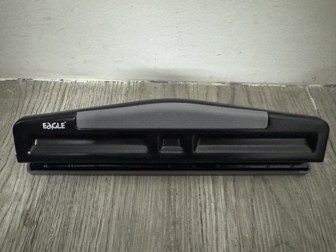 Eagle 3 Hole Punch Black (Category: Tshirts & Polo Shirts ) located in Manila. Submitted by decluterthings888 (Listing ID 1463216820, Image 1). Description: - Eagle brand 3 hole punch - Sleek black color with comfortable grey grip - Sturdy metal construction for durability - Easy to operate, perfect for office or school tasks - Designed for punching standard paper sizes.