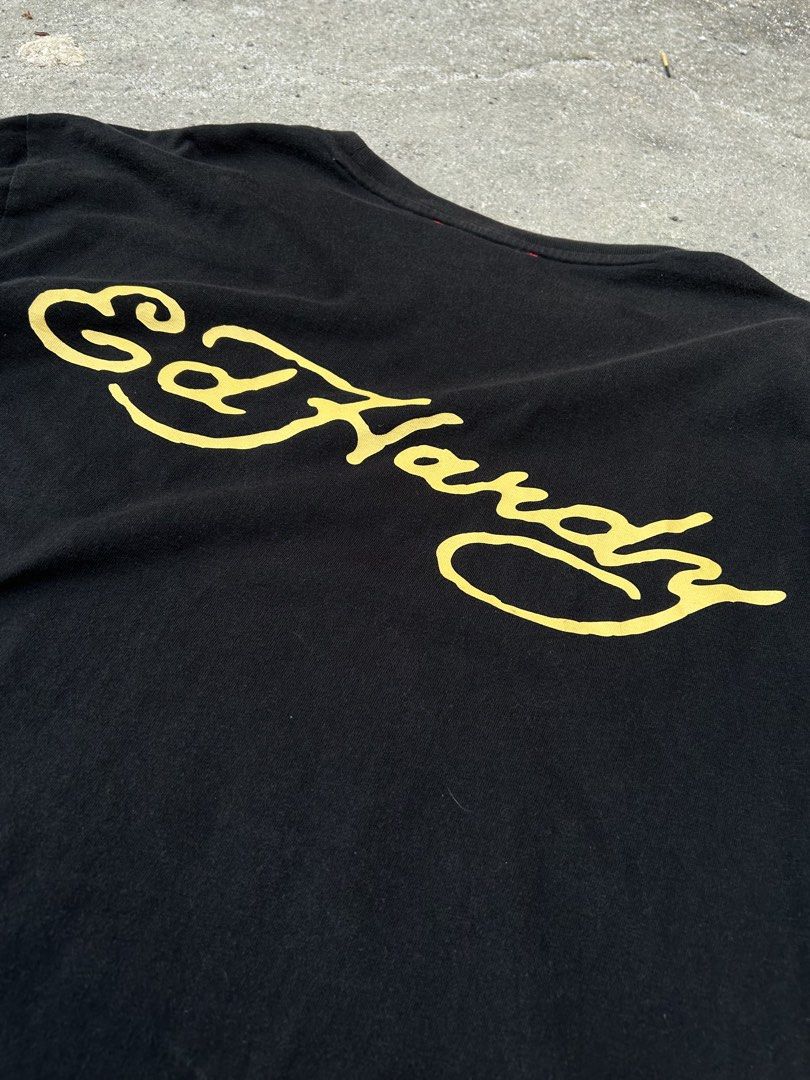 Ed Hardy Black T-Shirt with Tiger Patch (Category: Tshirts & Polo Shirts ) located in Angeles City. Submitted by luxy.thrifts (Listing ID 1463243197, Image 2). Description: - Black Ed Hardy T-shirt - Size L (based on tag) - Classic Ed Hardy script logo on the back - Cool tiger patch on the front left chest - Ed Hardy branding tape on the collar -Angeles City, Pampanga 📍 .