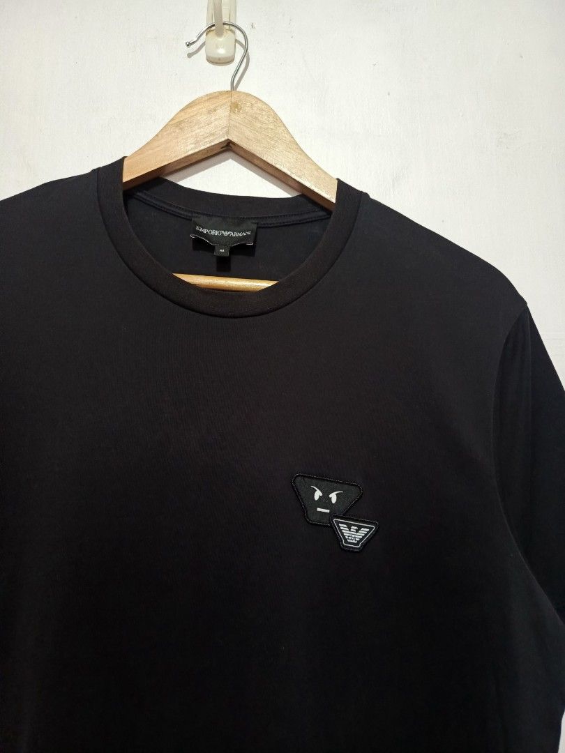 EMPORIO ARMANI SHIRT (Category: Tshirts & Polo Shirts ) located in Baguio. Submitted by 074thriftmania (Listing ID 1463272702, Image 2). Description: - Brand: Emporio Armani - Color: Black - Size: Medium (M) - Design: Iconic eagle logo with a fun graphic detail on the chest - Occasion: Ideal for casual wear - Origin: Made in China length 27" width 20".