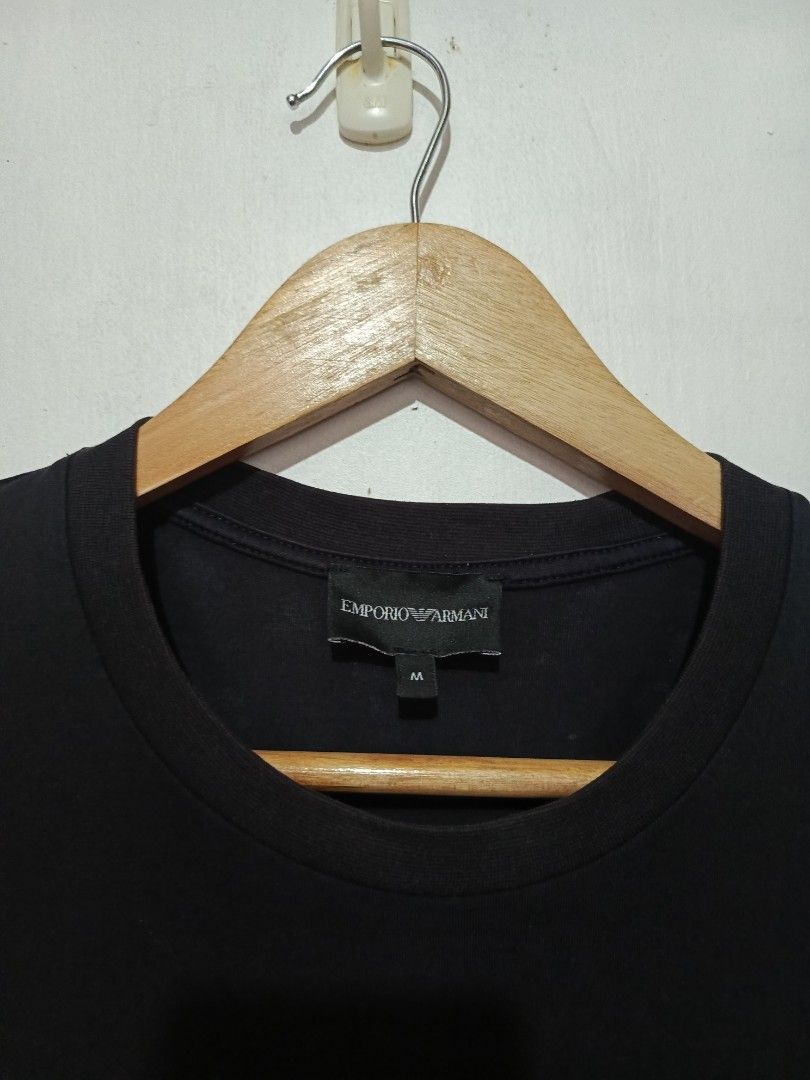 EMPORIO ARMANI SHIRT (Category: Tshirts & Polo Shirts ) located in Baguio. Submitted by 074thriftmania (Listing ID 1463272702, Image 3). Description: - Brand: Emporio Armani - Color: Black - Size: Medium (M) - Design: Iconic eagle logo with a fun graphic detail on the chest - Occasion: Ideal for casual wear - Origin: Made in China length 27" width 20".