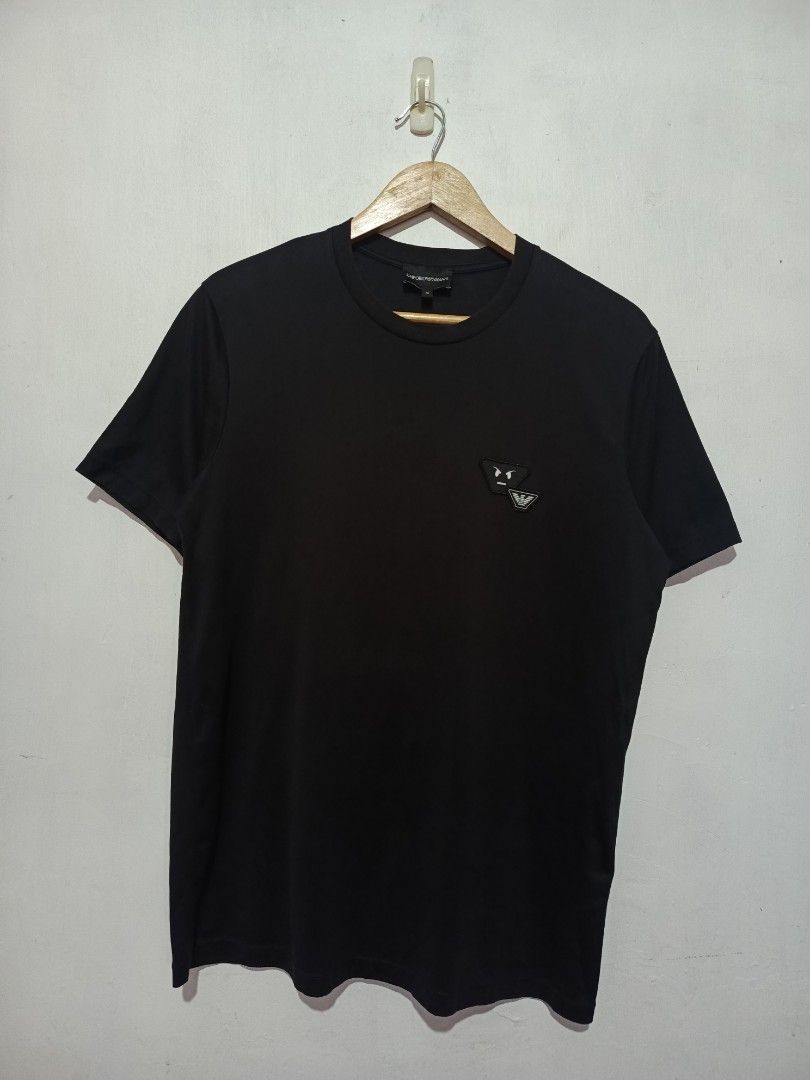 EMPORIO ARMANI SHIRT (Category: Tshirts & Polo Shirts ) located in Baguio. Submitted by 074thriftmania (Listing ID 1463272702, Image 1). Description: - Brand: Emporio Armani - Color: Black - Size: Medium (M) - Design: Iconic eagle logo with a fun graphic detail on the chest - Occasion: Ideal for casual wear - Origin: Made in China length 27" width 20".