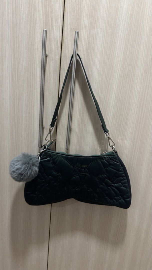 Fallen Angels Quilted Shoulder Bag with Pocket Charm (Category: Shoulder Bags) located in Taguig. Submitted by findfendifirst (Listing ID 1463239659, Image 3). Description: - Dark green quilted shoulder bag - Brand: Fallen Angels - Features a cute fluffy grey pom pom charm - Secure zipper closure - Adjustable strap for comfortable wear - Versatile for everyday use or a night out - Trendy and stylish design.