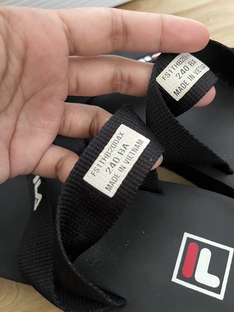 Fila Buster Unisex Slippers (Category: Flats & Sandals) located in Sariaya. Submitted by retro.stuff (Listing ID 1463151165, Image 3). Description: Fila Buster Unisex Slippers. Black. Size 240 BA on tag. Good fit sa 24.5cm feet. Made in Vietnam. Comfortable flip-flops with Fila logo. Slightly used. .