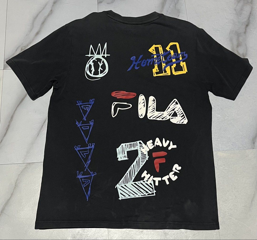 FILA Graphic T-Shirt (Category: Tshirts & Polo Shirts ) located in Cavite. Submitted by christianzuuu (Listing ID 1463134171, Image 2). Description: - Classic black Fila t-shirt - Eye-catching graphic prints on both front and back - Front features text and Fila logo - Back showcases multiple graphic elements and numbers - Short sleeves and comfortable crew neck - Ideal for casual everyday wear.