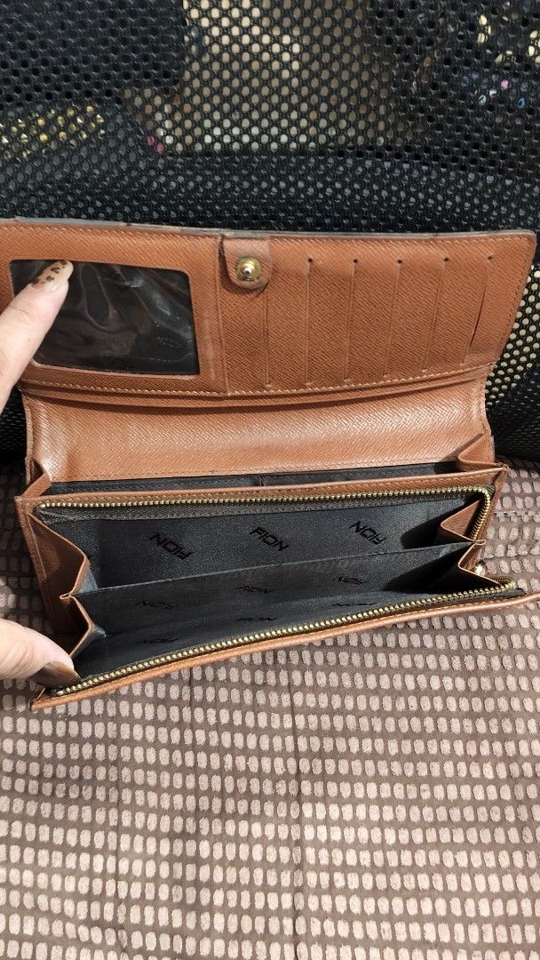 FION Brown Monogram Wallet (Category: Wallets & Card holders) located in Taguig. Submitted by ceefam.online.shop (Listing ID 1463148642, Image 2). Description: - Brown FION wallet with classic monogram pattern. - Ample card slots for all your cards. - Interior zippered compartment for coins or small items. - Secure snap closure to keep everything in place. - Excellent for organizing your daily essentials. - Shows some signs of wear, but remains f