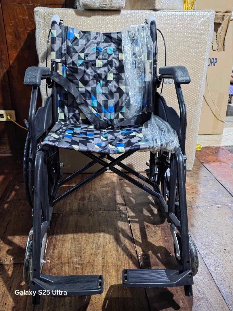 Foldable Wheelchair with Geometric Pattern Seat (Category: Wheelchairs) located in Manila. Submitted by brightflower_273879 (Listing ID 1463242642, Image 1). Description: - Lightweight and foldable for easy transport and storage - Comfortable seat with a stylish geometric pattern - Includes armrests and footrests for added support - Safety belt for enhanced security - Perfect for mobility assistance.