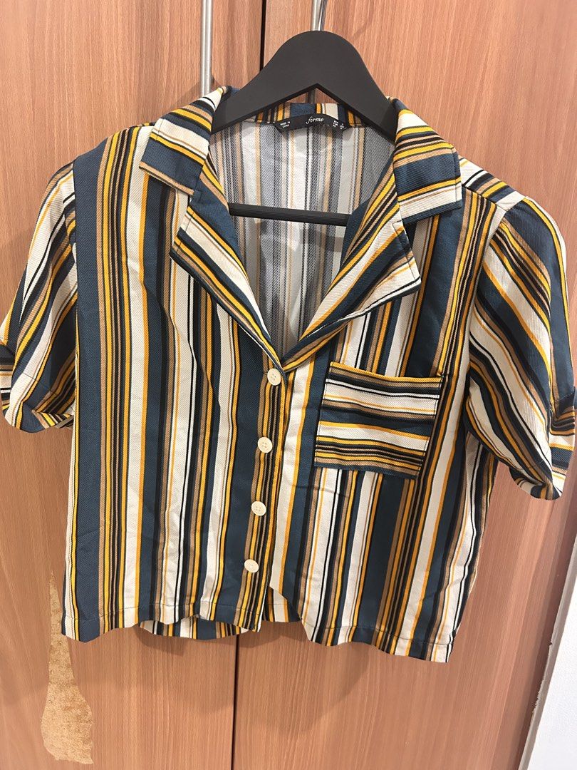 Forme Striped Button-Up Short Sleeve Shirt (Category: Shirts) located in Taguig. Submitted by peanutcoconut (Listing ID 1463274124, Image 2). Description: - Brand: Forme - Style: Short sleeve shirt - Features: Classic collar, button-up front, chest pocket with stripe detail - Colors: Dark green, yellow, white, black stripes - Styling: Pairs well with white pants or jeans for a casual outfit.