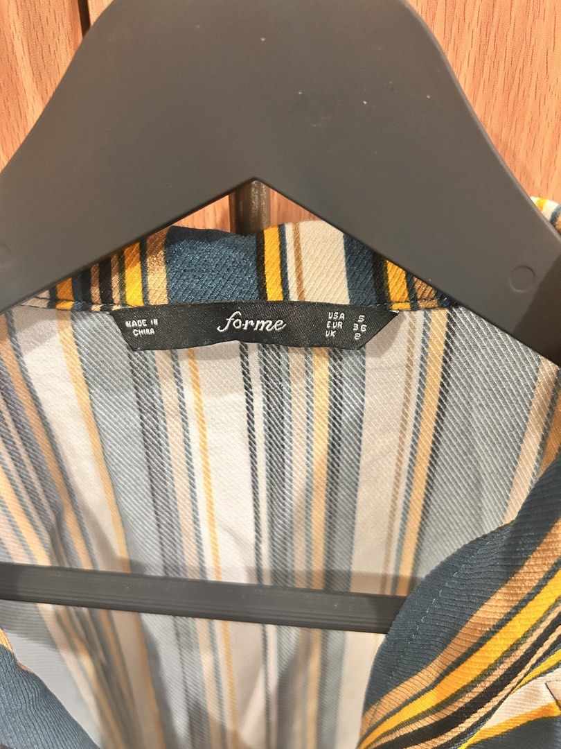 Forme Striped Button-Up Short Sleeve Shirt (Category: Shirts) located in Taguig. Submitted by peanutcoconut (Listing ID 1463274124, Image 3). Description: - Brand: Forme - Style: Short sleeve shirt - Features: Classic collar, button-up front, chest pocket with stripe detail - Colors: Dark green, yellow, white, black stripes - Styling: Pairs well with white pants or jeans for a casual outfit.