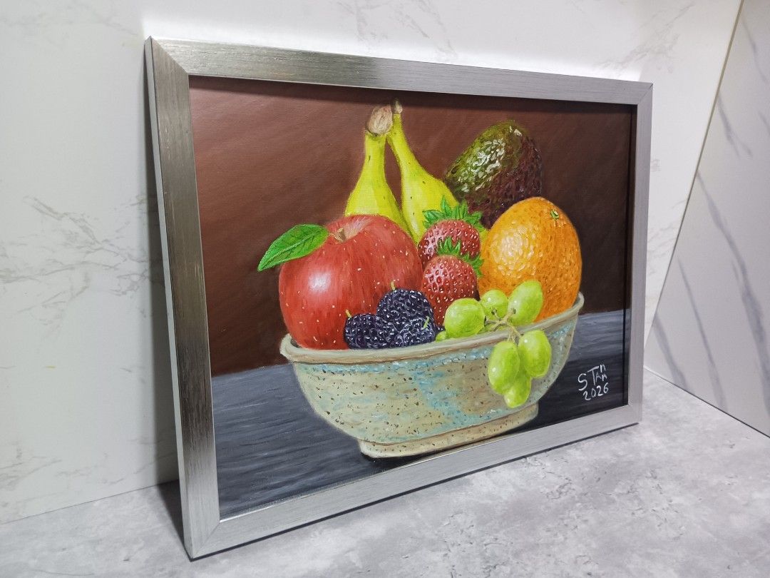 Framed Still Life Fruit Painting (Category: Art & Prints) located in Mandaluyong City. Submitted by alexstan2716850 (Listing ID 1463168863, Image 2). Description: - Original framed painting of a fruit bowl - Features a vibrant assortment of fruits: apples, strawberries, mulberries, grapes, bananas, avocado, and an orange - Comes with a stylish silver-toned frame - An excellent addition to enhance your home decor - 10 x 14 inches - Oil Paint on Ca