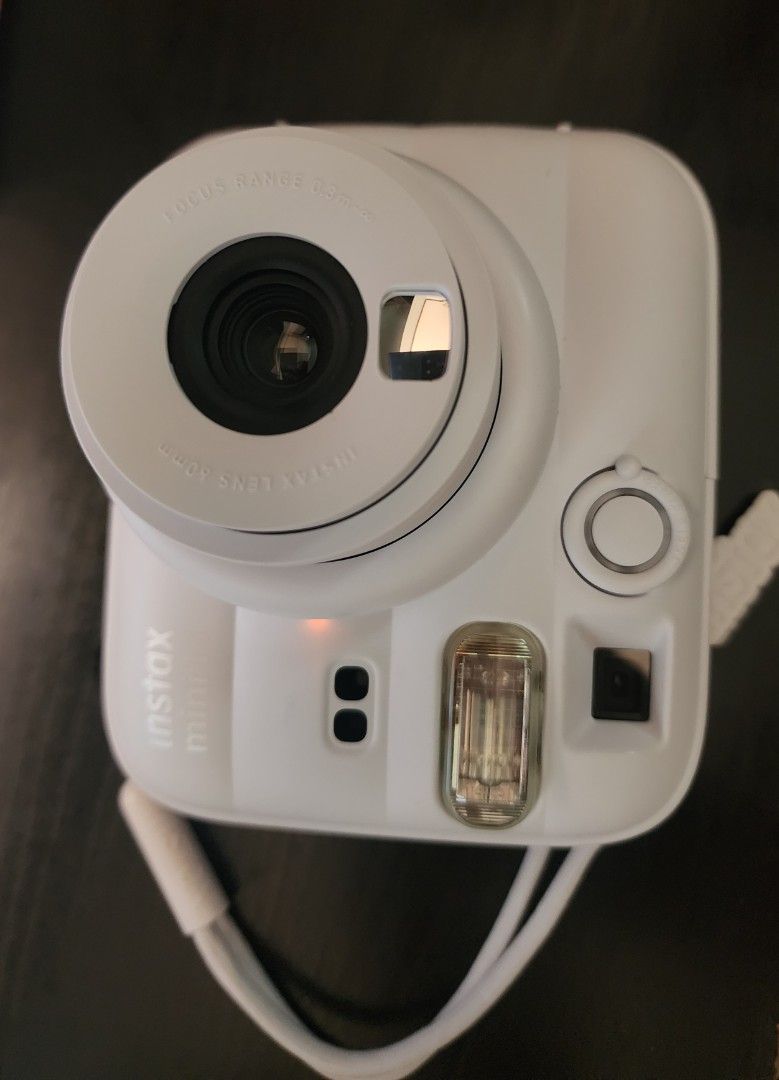 Fujifilm Instax Mini 13 White Instant Camera (Category: Cameras) located in Bacoor. Submitted by panikkiiigadgets (Listing ID 1463145046, Image 3). Description: - White Fujifilm Instax Mini 13 camera - Includes wrist strap and box - 60mm lens - Focus range: 0.3m and up - Ideal for instant photo memories -Used only once - Dubai trip -Purchased August 2026 .