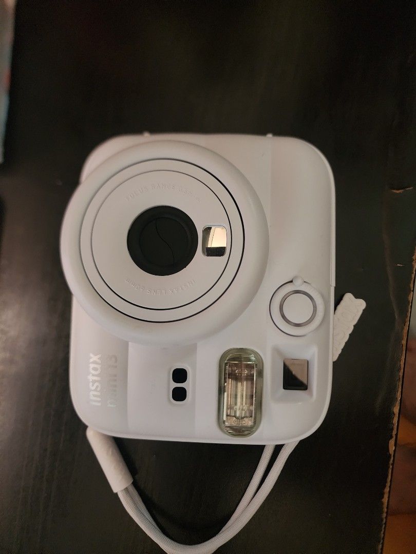 Fujifilm Instax Mini 13 White Instant Camera (Category: Cameras) located in Bacoor. Submitted by panikkiiigadgets (Listing ID 1463145046, Image 1). Description: - White Fujifilm Instax Mini 13 camera - Includes wrist strap and box - 60mm lens - Focus range: 0.3m and up - Ideal for instant photo memories -Used only once - Dubai trip -Purchased August 2026 .