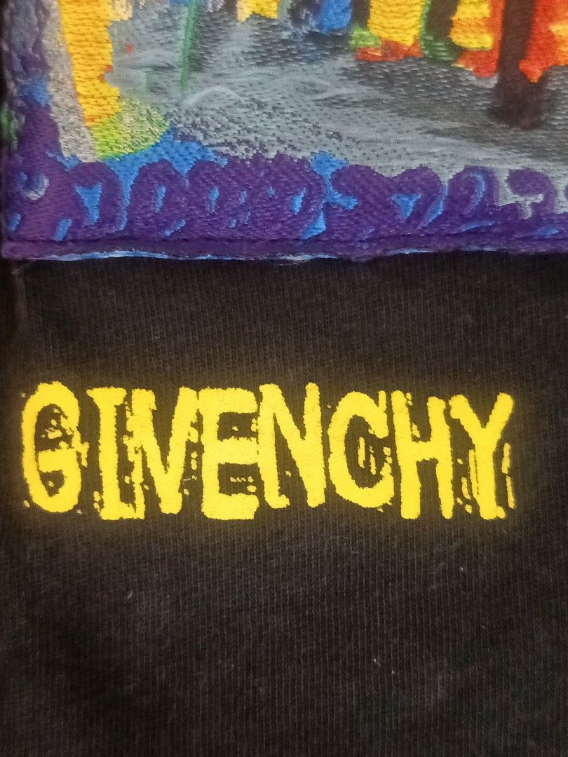 Givenchy x Josh Smith Graphic T-Shirt Black (Category: Tshirts & Polo Shirts ) located in Calamba. Submitted by sulitshopaholic (Listing ID 1463173378, Image 3). Description: - Black Givenchy T-Shirt - Features a colorful, abstract graphic print by artist Josh Smith - "GIVENCHY" and "JOSH SMITH" text printed below the graphic - Authentic Givenchy logo on inner tag - Ideal for collectors and fans of unique streetwear - Dimes: 27L X 22W.