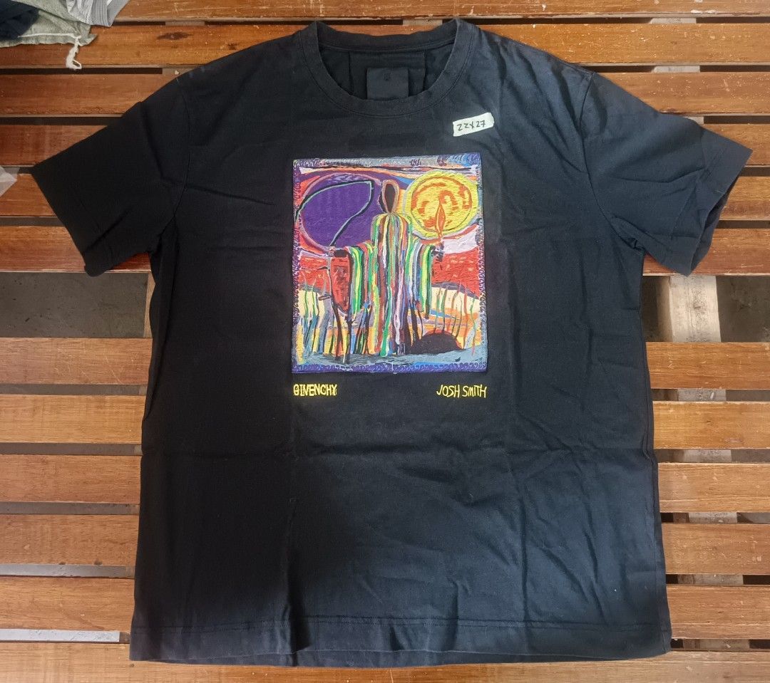 Givenchy x Josh Smith Graphic T-Shirt Black (Category: Tshirts & Polo Shirts ) located in Calamba. Submitted by sulitshopaholic (Listing ID 1463173378, Image 1). Description: - Black Givenchy T-Shirt - Features a colorful, abstract graphic print by artist Josh Smith - "GIVENCHY" and "JOSH SMITH" text printed below the graphic - Authentic Givenchy logo on inner tag - Ideal for collectors and fans of unique streetwear - Dimes: 27L X 22W.