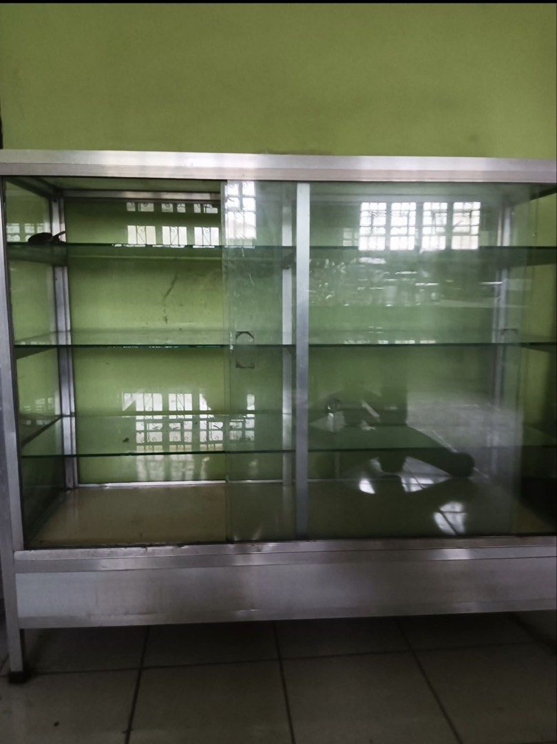 Glass Display Cabinet with Sliding Doors (Category: Shelves, Cabinets & Racks) located in Tanauan. Submitted by liltobysbakes (Listing ID 1463134232, Image 1). Description: - Sleek aluminum frame glass display cabinet - Multiple shelves for ample storage and display - Convenient sliding glass doors for easy access - Perfect for shops or home organization - Dimensions: Approx. [insert dimensions here if known].