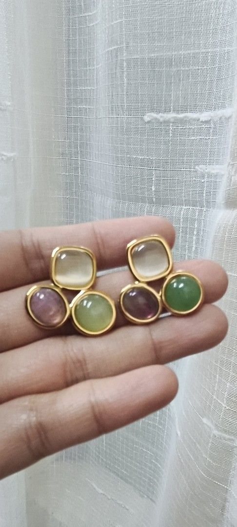 Gold Tone Earrings with Gemstones (Category: Earrings) located in Quezon City. Submitted by gemaicloset (Listing ID 1463202811, Image 1). Description: - Cute gold tone earrings - Features a square top gemstone and three round gemstones below - Gemstone colors: pale yellow, purple, and green - Unique design - Perfect for adding a pop of color to any outfit.
