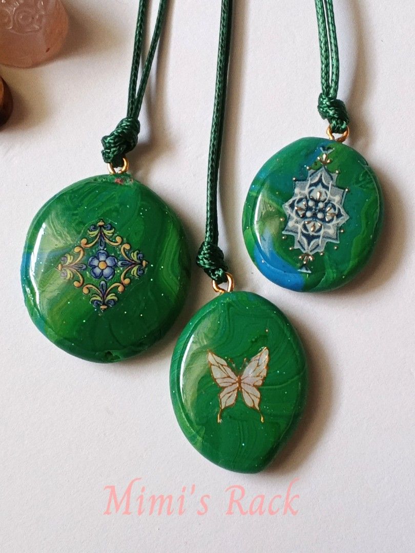 Green Handmade Decoupage Art Necklace (Category: Necklaces) located in Taguig. Submitted by mimisrack (Listing ID 1463323708, Image 2). Description: 💚Beautiful handcrafted green decoupage necklace featuring a glossy, colorful design with delicate floral, butterfly and ornamental motifs. -Each pendant has its own unique artwork, with subtle shimmer details and a polished finish that catches the light beautifully. ✨ -Perfect for those who love uni