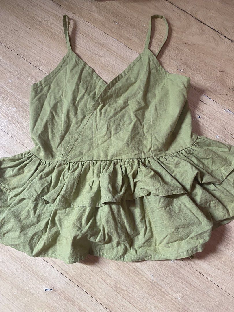 Green Ruffle Camisole Top (Category: Sleeveless) located in Tanauan. Submitted by rie098 (Listing ID 1463277345, Image 1). Description: - Adorable green camisole top - Features a two-tiered ruffled hem - Delicate spaghetti straps - Flattering V-neckline - Peplum-inspired silhouette - Versatile for casual outings or dressing up.