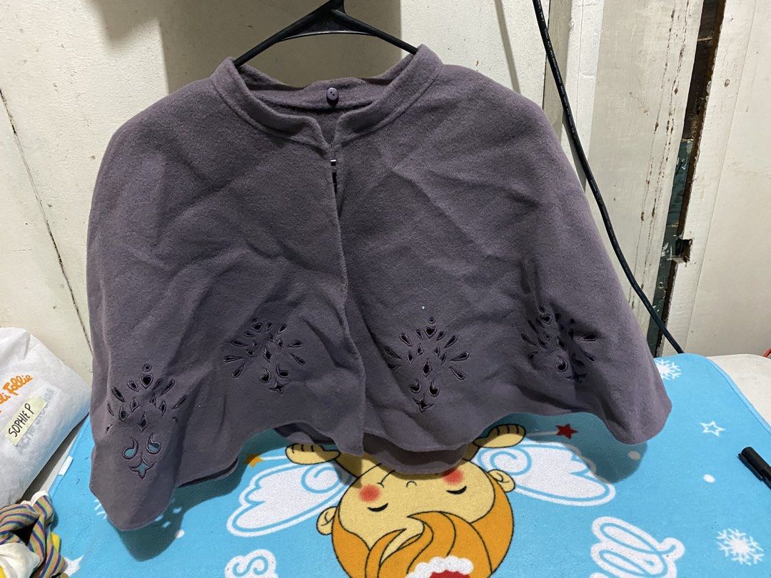 Grey Embroidered Cape with Button Closure (Category: Coats, Jackets and Outerwear) located in Manila. Submitted by resi.diaz (Listing ID 1463287352, Image 1). Description: - Soft and cozy grey cape - Features delicate cut-out embroidery along the hem - Simple button closure at the neck - Ideal for layering over any outfit - Measures approximately X inches long.