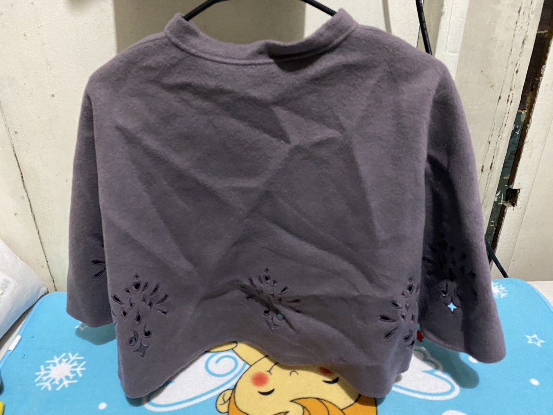 Grey Embroidered Cape with Button Closure (Category: Coats, Jackets and Outerwear) located in Manila. Submitted by resi.diaz (Listing ID 1463287352, Image 2). Description: - Soft and cozy grey cape - Features delicate cut-out embroidery along the hem - Simple button closure at the neck - Ideal for layering over any outfit - Measures approximately X inches long.