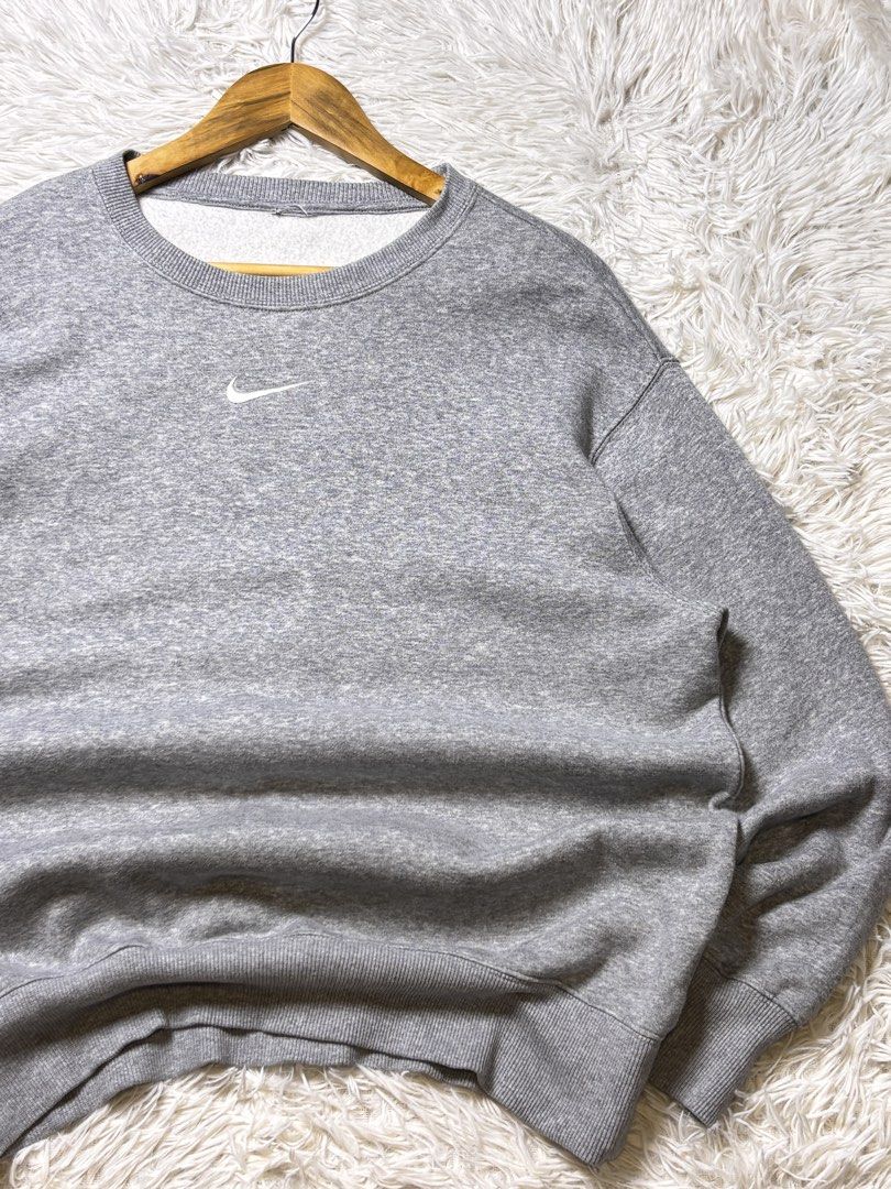 Grey Nike Crewneck Sweatshirt (Category: Coats, Jackets and Outerwear) located in Catbalogan. Submitted by christopszxc31 (Listing ID 1463279335, Image 2). Description: - Classic grey Nike sweatshirt - Simple swoosh logo on the chest - Crewneck style - 22x27 Large to XLarge - Ribbed cuffs and hem - Comfortable, everyday piece - Measurements shown in photos - Great for casual wear.