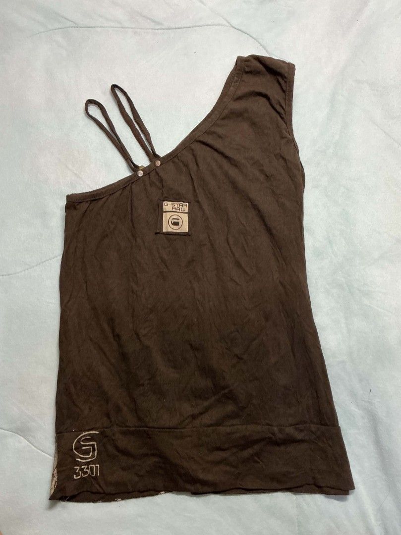 G-Star Raw One Shoulder Top (Category: Blouses) located in Binan City. Submitted by myks_thrift (Listing ID 1463249373, Image 2). Description: - Brown G-Star Raw one-shoulder top - Features strap details - Metal eyelet details at the hem - Graphic print on front and back - Ideal for casual wear.