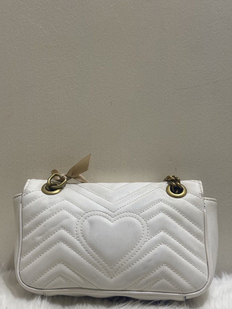 Gucci GG Marmont Matelassé Shoulder Bag (Category: Cross-body Bags) located in Quezon City. Submitted by clazzystudio (Listing ID 1463261421, Image 3). Description: Selling this classic Gucci GG Marmont shoulder bag in crisp white matelassé chevron quilted leather. Features the iconic antique gold-tone Double G logo hardware on the front flap and a chain shoulder strap with leather pad detail (tied with a ribbon). A timeless luxury piece that ins