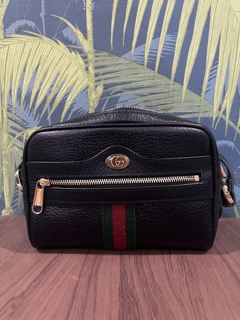 Gucci Black Leather Ophidia Camera Bag (Category: Luxury Bags & Wallets) located in Paranaque City. Submitted by katlopez0214 (Listing ID 1463238055, Image 1). Description: - Authentic Black Leather Gucci Camera Bag - Gold Hardware - Signature Green and Red Stripe - Secure Zip Closure - Interior Pocket - Convenient Keychain Clip - Adjustable Strap for Comfort - Ideal for Everyday Use.