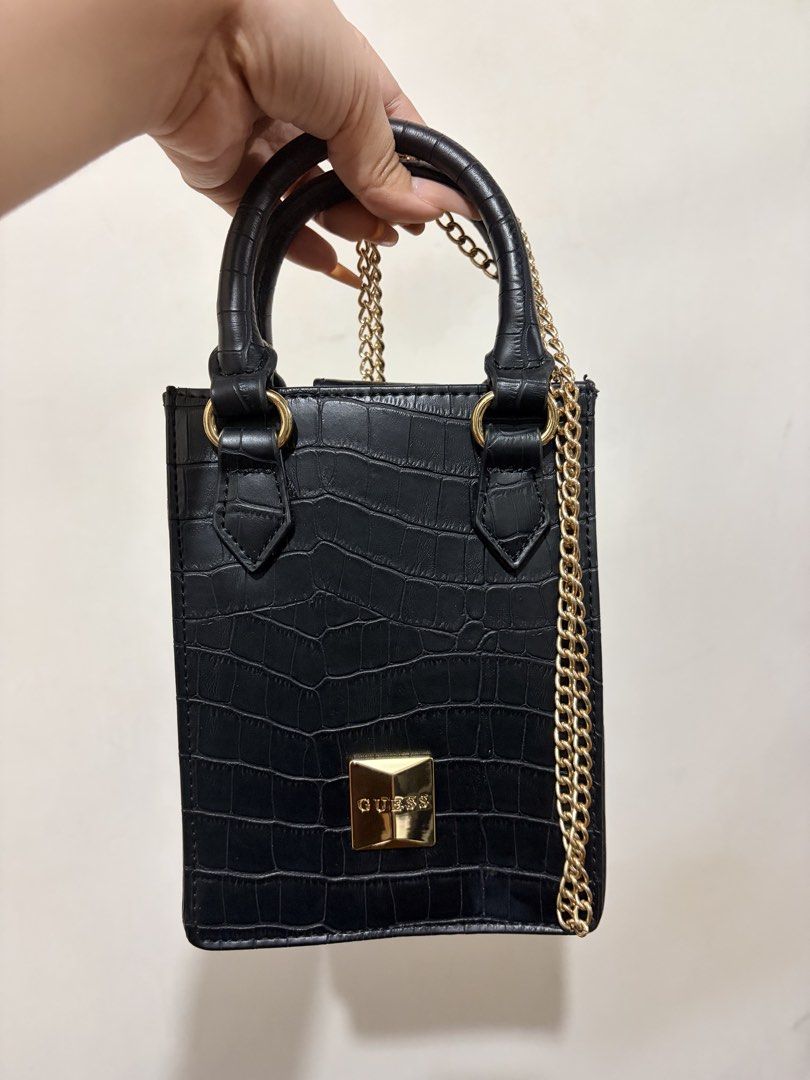 GUESS Black Croc-Embossed Mini Bag / Crossbody (Category: Cross-body Bags) located in Antipolo. Submitted by babybluear78052 (Listing ID 1463314139, Image 1). Description: GUESS mini structured bag in black croc-embossed finish with gold hardware 🖤 Can be worn as a handbag or crossbody/shoulder bag with the gold chain strap. * Black croc-embossed material * Gold GUESS hardware * Top handles * Gold chain strap * Structured shape * Very cute compa