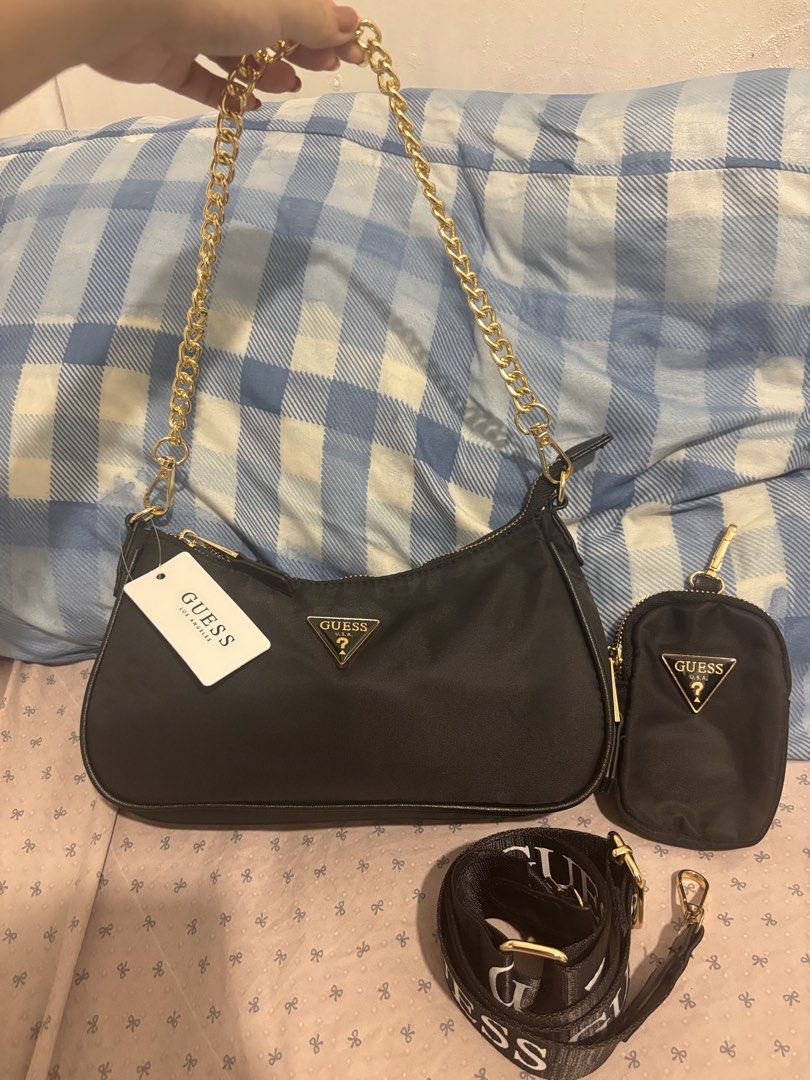 Guess Black Nylon Shoulder Bag with Pouch and Strap (Category: Shoulder Bags) located in Lapu Lapu. Submitted by affordmo (Listing ID 1463222157, Image 1). Description: - Guess black nylon shoulder bag - Comes with a matching pouch - Includes a branded crossbody strap - Also includes a gold chain strap - Interior features Guess logo lining - Ideal for everyday use.