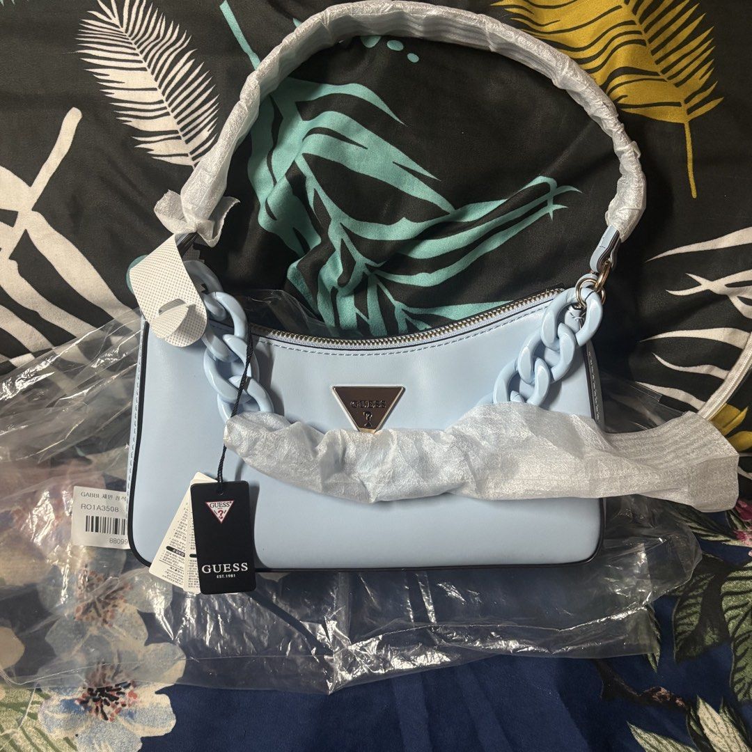 Guess Gabbi Shoulder Bag Light Blue (Category: Shoulder Bags) located in Manila. Submitted by archivebaek (Listing ID 1463280752, Image 1). Description: - Brand new Guess Gabbi Hobo Shoulder Bag in Light Blue - Features a stylish chunky chain strap - Comes with original tags and packaging (plastic only) - Purchased directly from South Korea - Original price: around ₱4000 - Selling price: ₱2950 MOP: Gcash, Maribank, Gotyme MOD : Lalamove or J&T (S