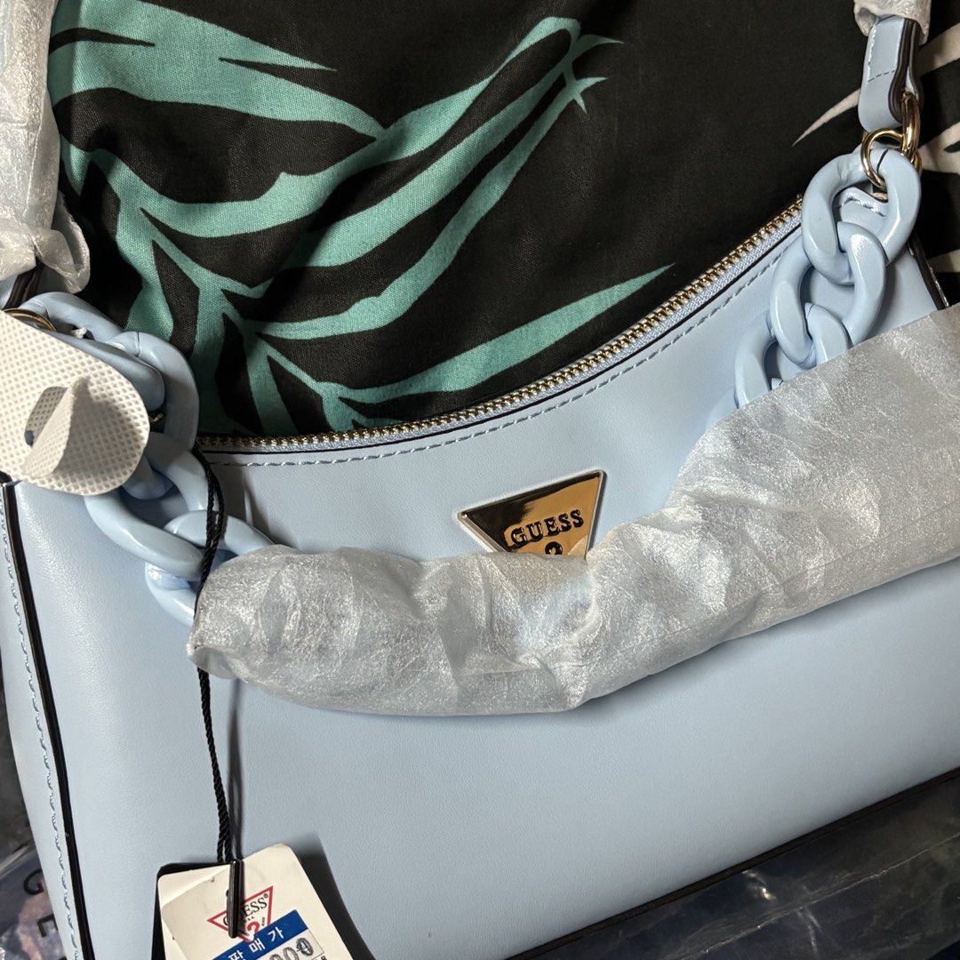 Guess Gabbi Shoulder Bag Light Blue (Category: Shoulder Bags) located in Manila. Submitted by archivebaek (Listing ID 1463280752, Image 2). Description: - Brand new Guess Gabbi Hobo Shoulder Bag in Light Blue - Features a stylish chunky chain strap - Comes with original tags and packaging (plastic only) - Purchased directly from South Korea - Original price: around ₱4000 - Selling price: ₱2950 MOP: Gcash, Maribank, Gotyme MOD : Lalamove or J&T (S