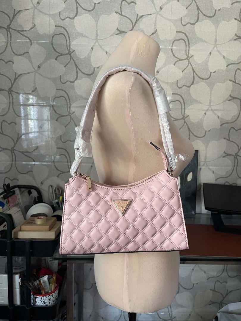 Guess Gully Quilted Shoulder Bag in Peony (Category: Shoulder Bags) located in Manila. Submitted by najiecart (Listing ID 1463325554, Image 2). Description: - Brand new pink Guess shoulder bag - Elegant quilted design - Chic gold hardware - Secure zipper closure - Interior Guess logo lining - Convenient interior zip pocket - Comes with original dust bag - Strap still has protective plastic on it.