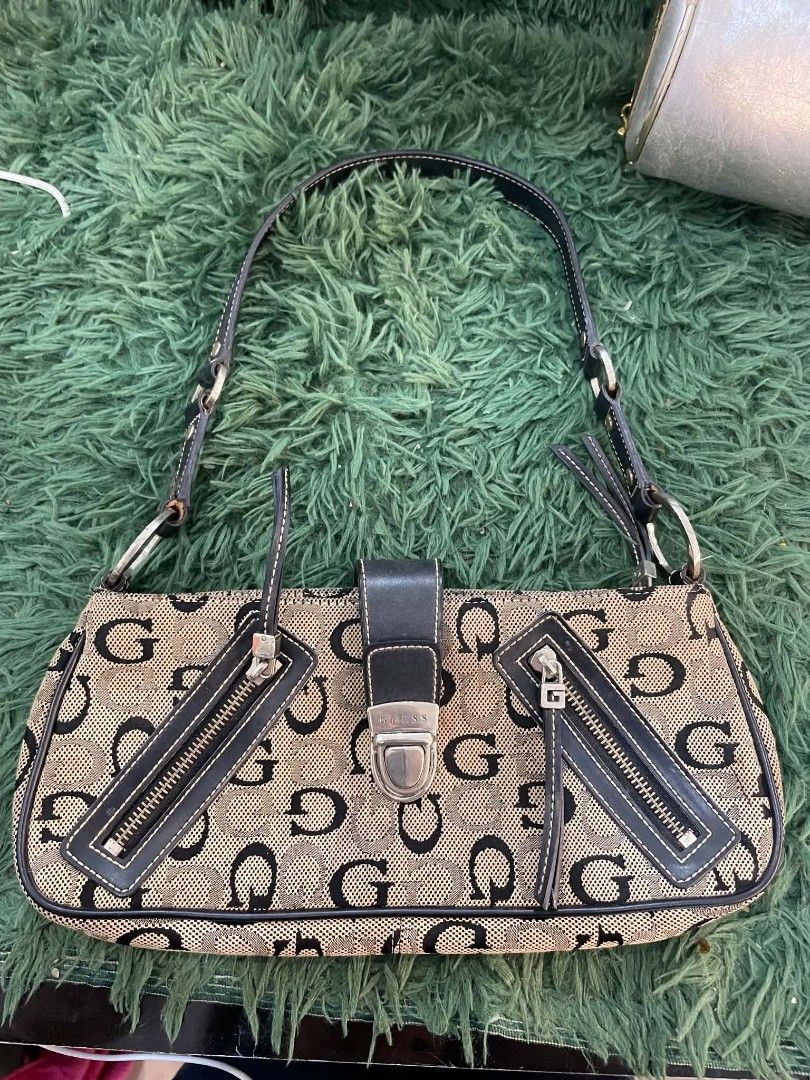 Guess Monogram Shoulder Bag (Category: Luxury Bags & Wallets) located in Cainta. Submitted by mariss.luxx (Listing ID 1463239057, Image 1). Description: - Classic Guess monogram shoulder bag - Beige and black GG pattern - Black leather trim and strap - Zippered pocket on the back - Two decorative zippered pockets on the front - Buckle closure - Silver hardware - Ideal for everyday use.
