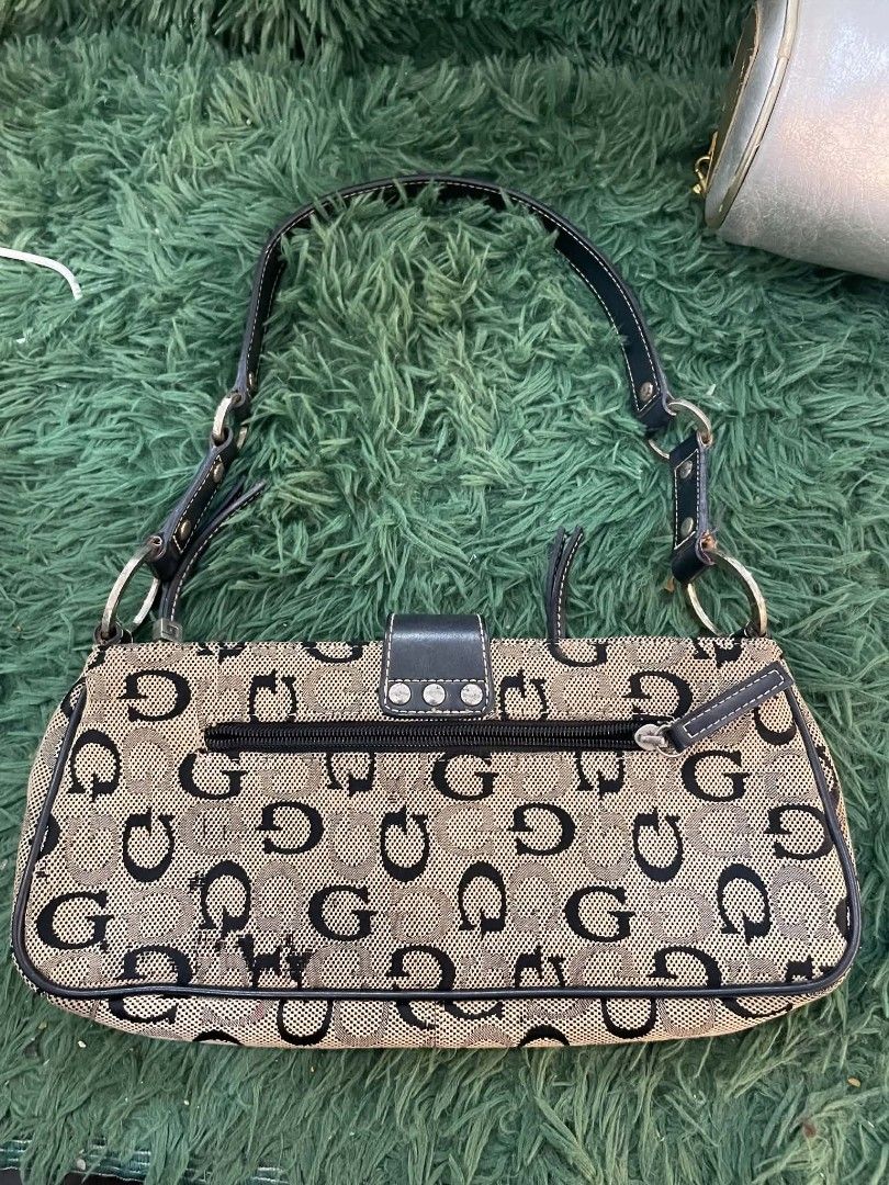Guess Monogram Shoulder Bag (Category: Luxury Bags & Wallets) located in Cainta. Submitted by mariss.luxx (Listing ID 1463239057, Image 2). Description: - Classic Guess monogram shoulder bag - Beige and black GG pattern - Black leather trim and strap - Zippered pocket on the back - Two decorative zippered pockets on the front - Buckle closure - Silver hardware - Ideal for everyday use.