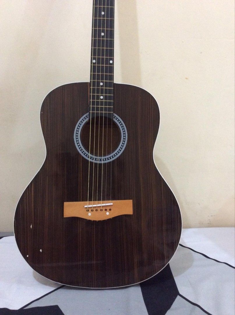Guitar (Category: Musical Instruments) located in Manila. Submitted by zen_almero (Listing ID 1457508148, Image 3). Description: - Dark wood body finish - Black neck and fretboard - Six tuning pegs - Standard bridge and saddle - Ideal for beginners and experienced players - Ready for strumming.