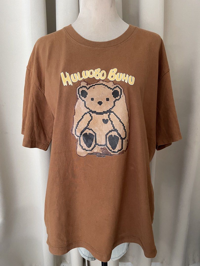 HEAVY COTTON Brown Bear (Category: Shirts) located in Cainta. Submitted by zlove111 (Listing ID 1463178459, Image 1). Description: - Cute brown t-shirt - Oversized fit for maximum comfort - Features a pixelated bear graphic - Text above bear reads 'HULUOBO BUHU' - Perfect for casual everyday wear - Looks great with jeans or shorts 23" .