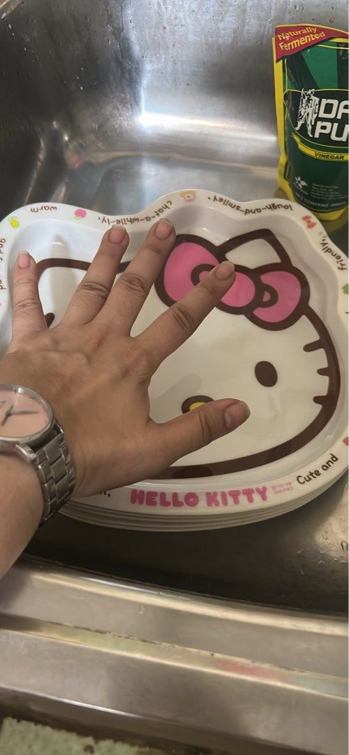 Hello Kitty Melaware Dish (Category: Other Kitchenware & Tableware) located in Taytay. Submitted by tonieboobonie (Listing ID 1463122319, Image 2). Description: - Adorable Kitty 5 pcs dish plus free Knife and cutting board - Ideal for small meals, snacks, trinkets, or decor - Fun words on the rim: 'warm', 'friendly', 'cute', 'trendy' - Perfect gift for Kitty enthusiasts - Approximate size: [hand size reference].