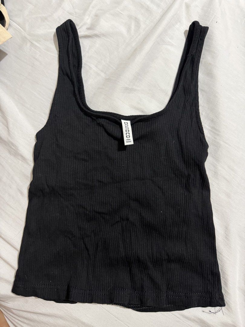 H&M Divided Black Ribbed Tank Top (Category: Sleeveless) located in Manila. Submitted by bexxyah (Listing ID 1463263185, Image 1). Description: - Brand: H&M Divided - Color: Black - Style: Ribbed tank top - Neckline: Square - Straps: Thick - Material: Stretchy for comfort - Versatile: Great for layering or wearing on its own - Easy to style with any outfit.