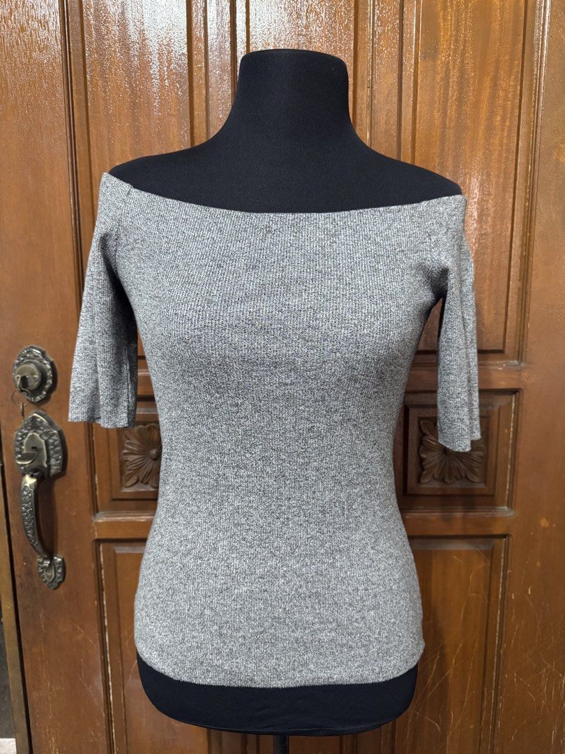 H&M Grey Off-Shoulder Ribbed Knit Top (Category: Blouses) located in Manila. Submitted by prelovedshopmnl (Listing ID 1463144901, Image 1). Description: - Grey off-shoulder top from H&M - Ribbed knit material - Three-quarter sleeves - Fitted silhouette - Perfect for dressing up or down - Easily pairs with skirts or jeans.