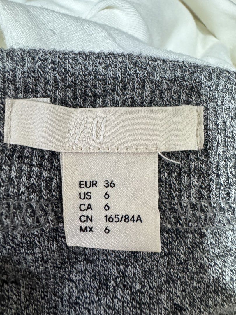 H&M Grey Off-Shoulder Ribbed Knit Top (Category: Blouses) located in Manila. Submitted by prelovedshopmnl (Listing ID 1463144901, Image 3). Description: - Grey off-shoulder top from H&M - Ribbed knit material - Three-quarter sleeves - Fitted silhouette - Perfect for dressing up or down - Easily pairs with skirts or jeans.
