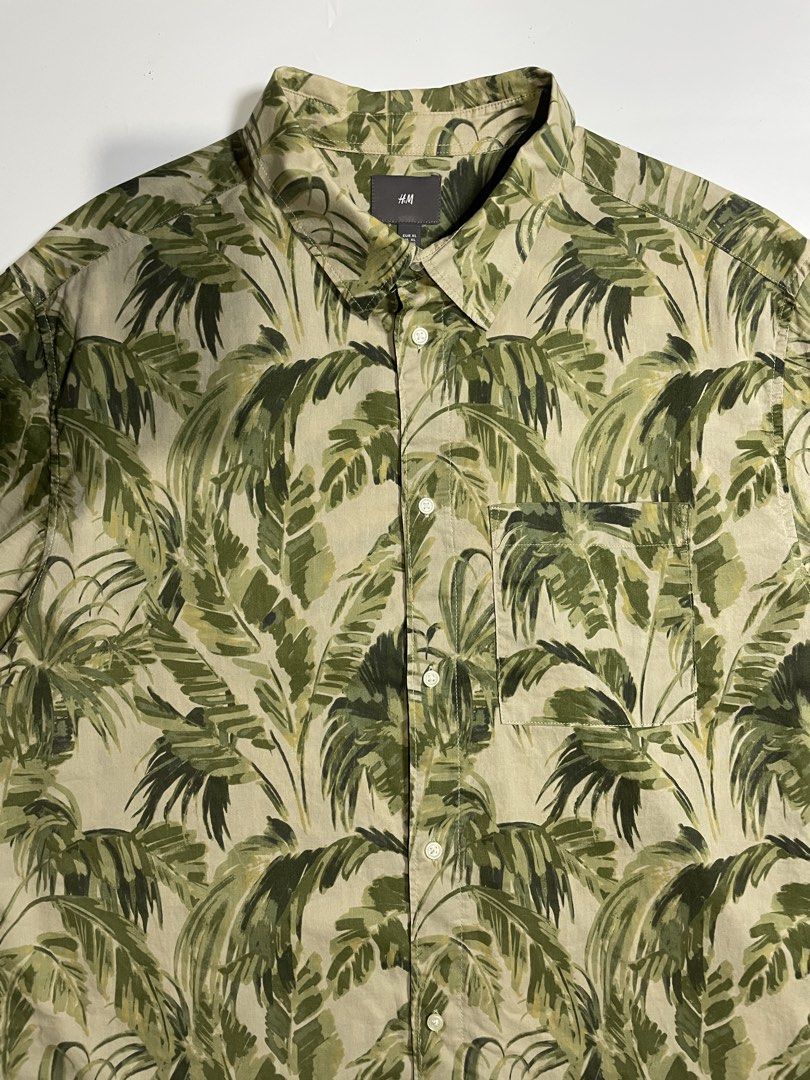 H&M tropical button down shirt (Category: Tshirts & Polo Shirts ) located in Bais. Submitted by christian.complexthrift08 (Listing ID 1463294437, Image 2). Description: H&M tropical button down shirt (In like New Condition) Color: olive / khaki Size: XLarge on tag Width: 25 inches Length: 30 inches Condition: 9.7 / 10 Issue: Price: 550 + SF Via JNT express.