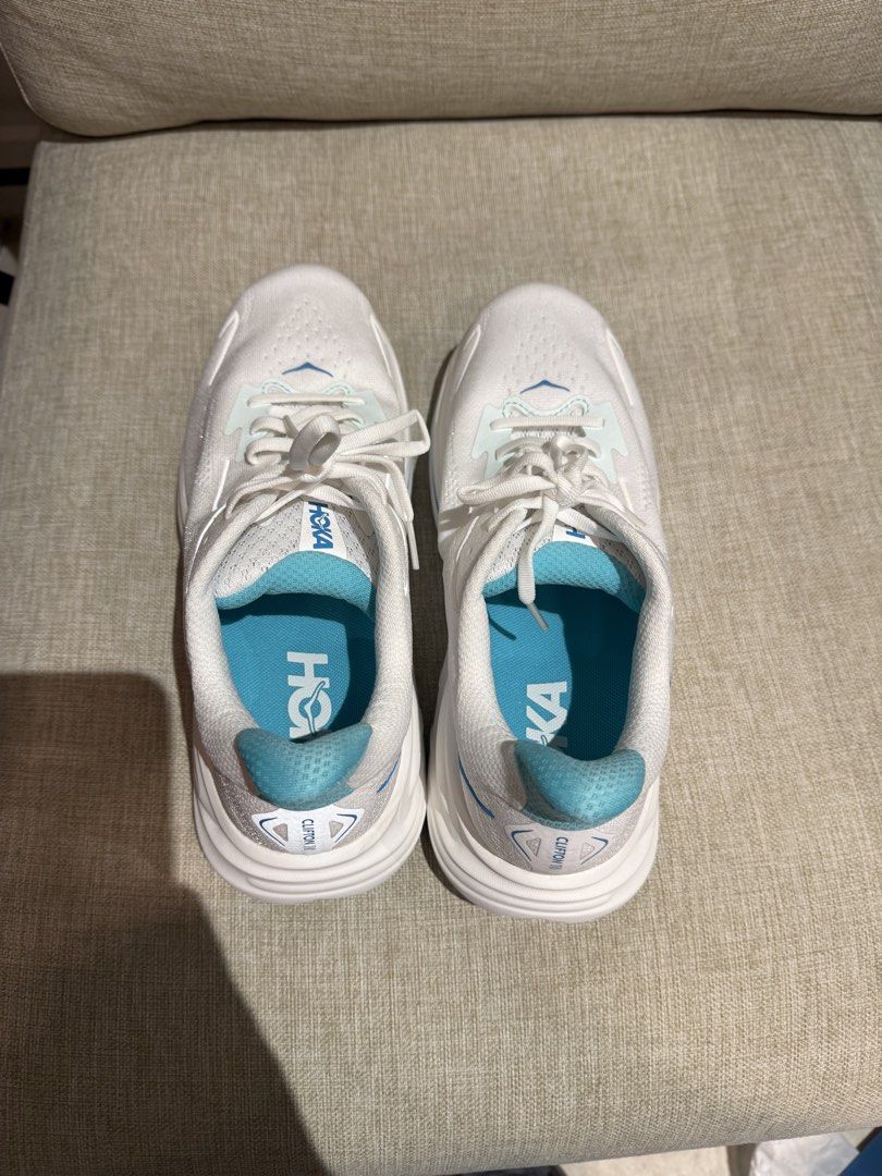 Hoka Clifton 10 Running Shoes (Category: Sneakers) located in Makati City. Submitted by ggbuckets (Listing ID 1463264809, Image 3). Description: - Brand: Hoka - Model: Clifton 10 - Color: White with blue accents - Size: 9D (US Men's) - Condition: Brand New - Includes: Original Hoka box and packaging .
