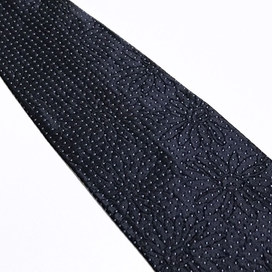 Hugo Boss Micro Dot Deep Navy Neck Tie (Category: Ties) located in Taguig. Submitted by retrogaze (Listing ID 1463201456, Image 3). Description: This vintage 100% silk necktie by Hugo Boss features a deep navy blue base with a rich, multi-layered jacquard weave. The body displays a subtle, tonal shadowed floral motif woven directly into the background, overlaid with a dense, repeating grid of micro light grey diamond dots. Recommended Suit & Shir