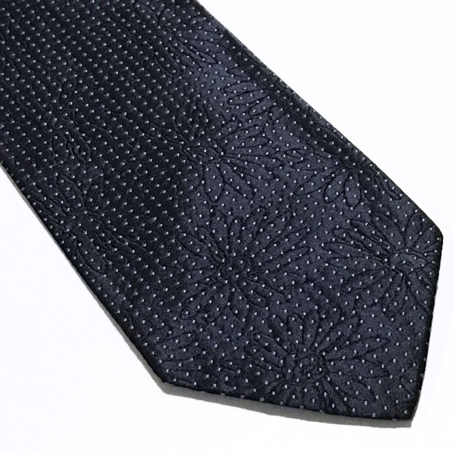 Hugo Boss Micro Dot Deep Navy Neck Tie (Category: Ties) located in Taguig. Submitted by retrogaze (Listing ID 1463201456, Image 2). Description: This vintage 100% silk necktie by Hugo Boss features a deep navy blue base with a rich, multi-layered jacquard weave. The body displays a subtle, tonal shadowed floral motif woven directly into the background, overlaid with a dense, repeating grid of micro light grey diamond dots. Recommended Suit & Shir