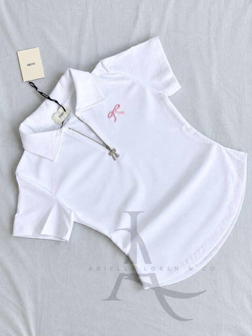 IVORY BRAND - Quarter Zip Collared White Shirt (Category: Blouses) located in Manila. Submitted by ariellelorenco (Listing ID 1463129496, Image 3). Description: 👉🏻Color: White 👉🏻Ivory Brand 👉🏻Can fit up to XL 👉🏻Bust size up to 40 in max 👉🏻Stretchy fabric 👉🏻Quarter zip (working zipper) 👉🏻With pink embroidered ribbon detail 👉🏻With side ruched on both sides ***These are all actual photos ***Colors may vary due to lighting .