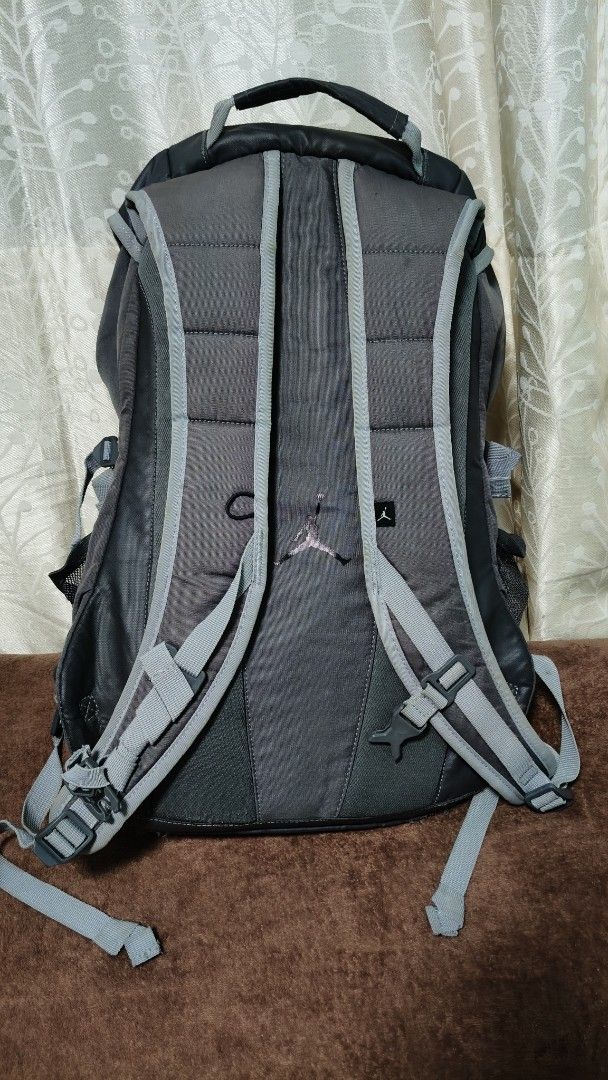 Jordan Black Grey Backpack (Category: Backpacks) located in Manila. Submitted by serenitycarlylle (Listing ID 1463300710, Image 3). Description: - Stylish black and grey Jordan backpack. - Main compartment with secure drawstring and buckle closure. - Convenient front mesh pocket with zippers. - Dual side mesh pockets perfect for water bottles. - Comfortable padded shoulder straps. - Please note: Some wear on the strap as pictured..