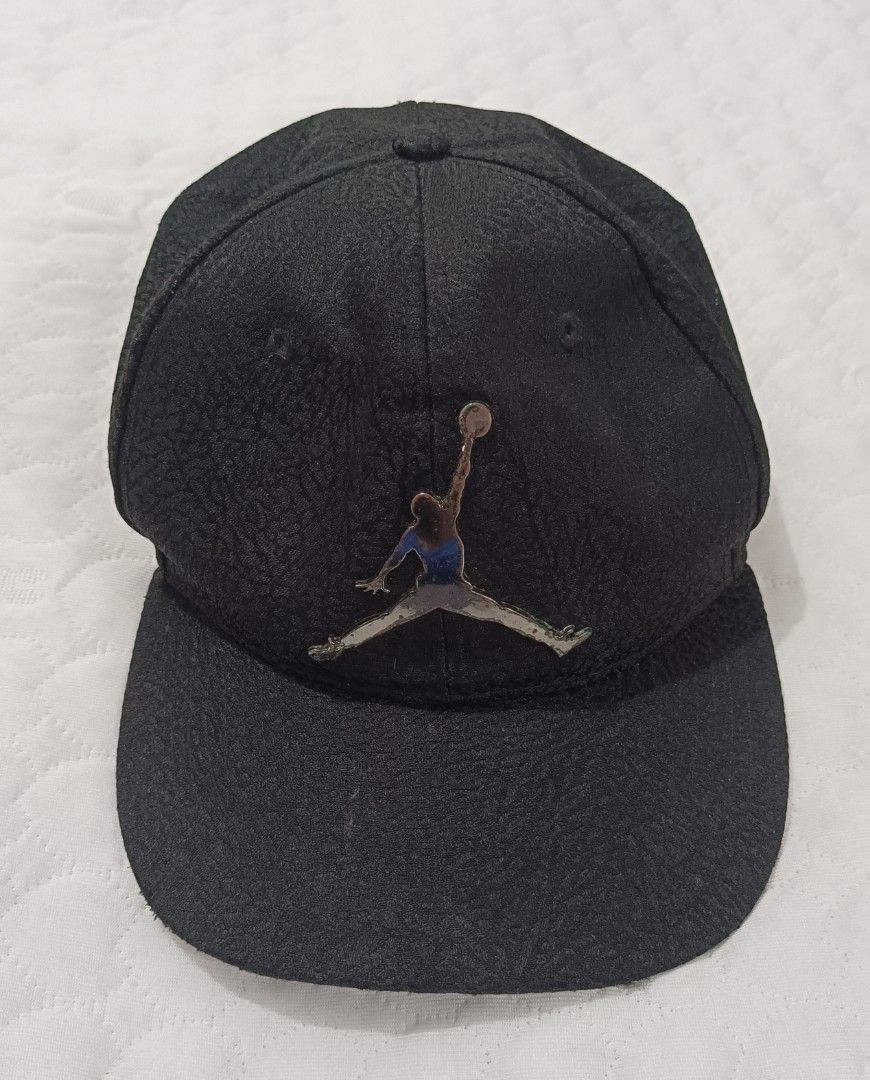 Jordan Jumpman Snapback Cap Black Elephant Skin (Category: Caps & Hats) located in Pasig City. Submitted by joaquin_1207 (Listing ID 1463281068, Image 1). Description: - Black Jordan snapback cap - Features iconic Jumpman logo on the front - Textured material for a premium feel - Adjustable strap at the back for a customized fit - Ideal for any fan of Michael Jordan and the Jordan brand.