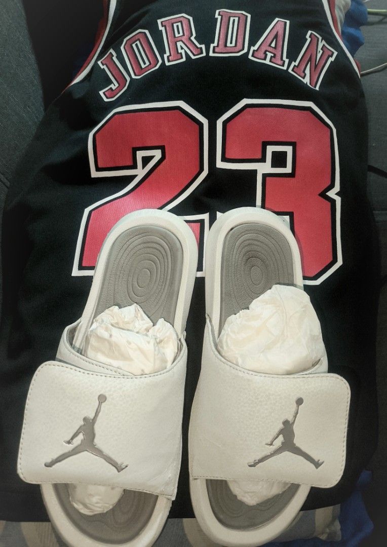 Jordan Slides (Category: Slippers and slides) located in Rizal. Submitted by youngwolf-5f02 (Listing ID 1463174558, Image 1). Description: - White Jordan slides, US size 6.5 - Black Michael Jordan #23 jersey - Ideal set for any Jordan enthusiast.