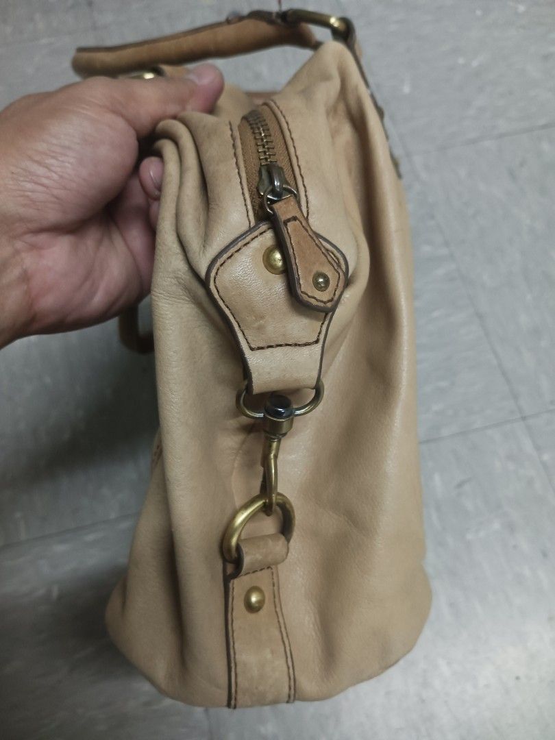 Julia M. Leather Shoulder Bag (Category: Luxury Bags & Wallets) located in Quezon City. Submitted by arvietekto (Listing ID 1463150181, Image 3). Description: Julia M. Genuine leather bag - Light brown leather shoulder bag - Multiple pockets on front and back - Main zipper closure - Interior zippered pocket - Darker brown shoulder straps - Minor marks on leather (especially the back) - Great for everyday use.