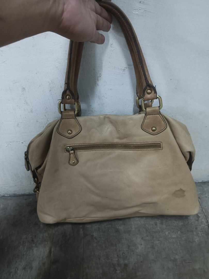Julia M. Leather Shoulder Bag (Category: Luxury Bags & Wallets) located in Quezon City. Submitted by arvietekto (Listing ID 1463150181, Image 2). Description: Julia M. Genuine leather bag - Light brown leather shoulder bag - Multiple pockets on front and back - Main zipper closure - Interior zippered pocket - Darker brown shoulder straps - Minor marks on leather (especially the back) - Great for everyday use.